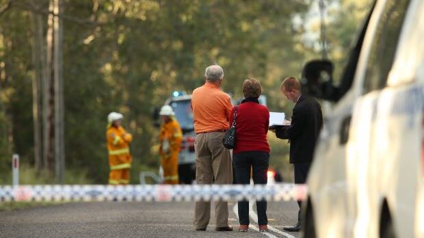 Police interview witnesses at a roadblock near the crash scene. Pic: Dean Osland