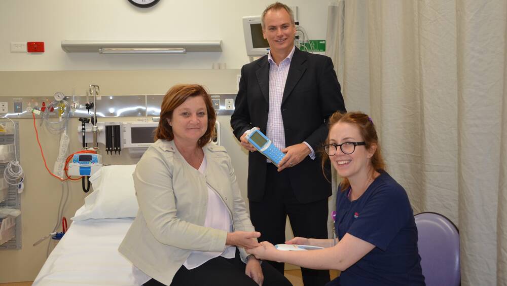 NEW INITIATIVE: Point of care testing (PoCT) manager Andrew Sargeant and Singleton District Hospital clinical nurse specialist Bridget Moberg try out the program on patient Peta Cooper.