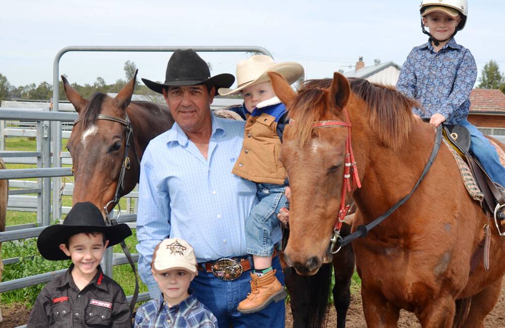 THIRD GENERATION RODEO RIDERS: From left, Lane Heffernan, Logan George, Robbie George holding Bailey George, and Riley George (on horse).