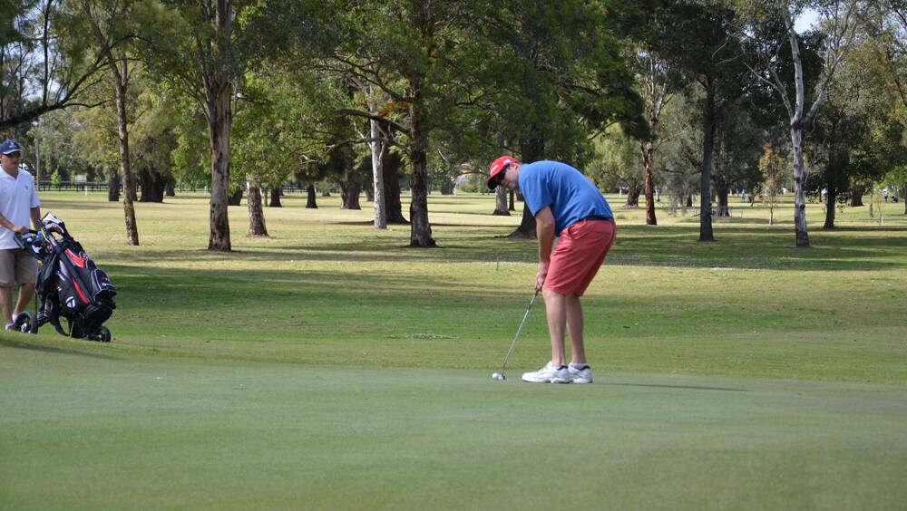 CONCENTRATION: George Gray lines up a putt at the Singleton Golf Club during round one of the championships.