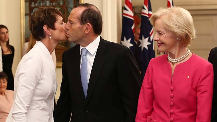 Tony Abbott kisses his wife Margie after being sworn in as Australia's 28th Prime Minister by Governor-General Quentin Bryce, right, today. Photo: Andrew Meares