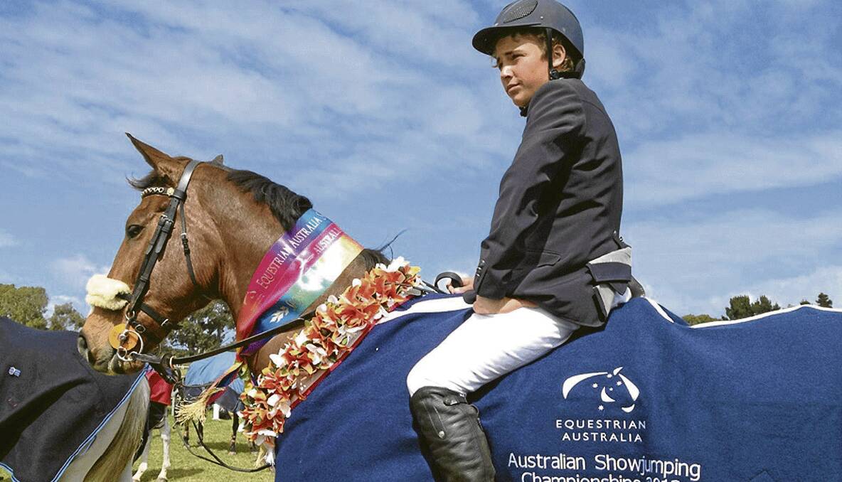 CHAMPION: Jake Hunter riding Midnight Rock at the Australian SHowjumping Championships during the school holidays.