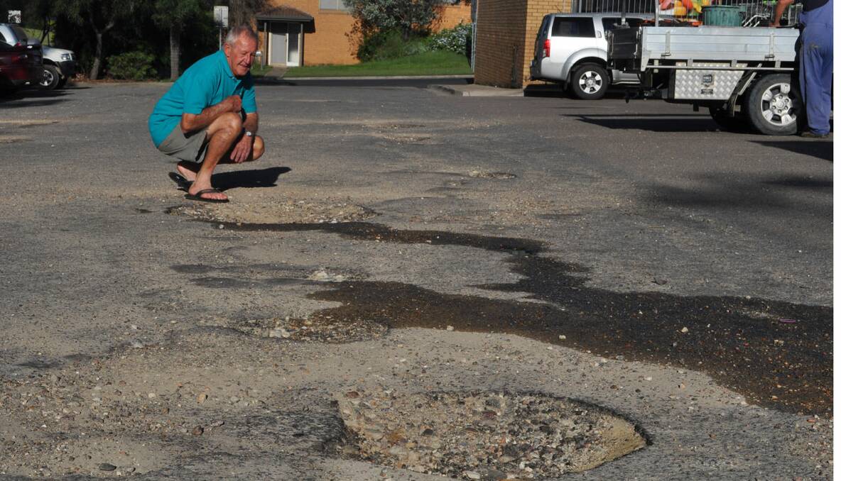 CONCERNED FOR FELLOW SHOPPERS: Singleton Heights resident Wayne Gardiner fears someone will end up breaking their hip in one of the pot holes. 