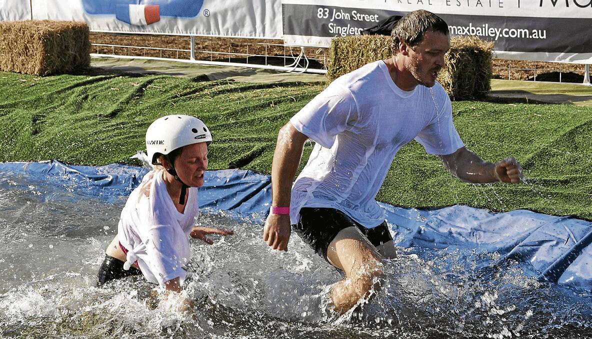 Ellie Gresham and Beau Mynard during their winning race at the Singleton Wife Carrying Title.