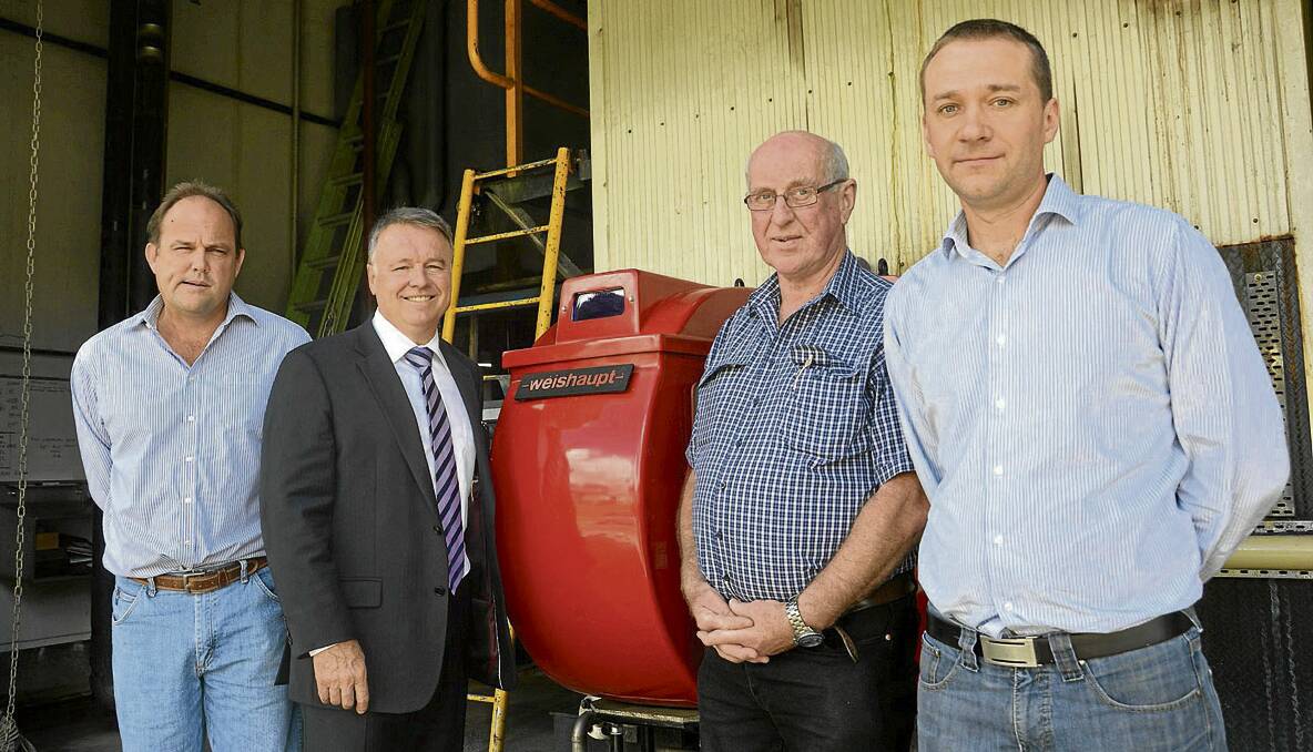 UP TO DATE: Director/owner Edward Throsby, Federal Member for Hunter Joel Fitzgibbon, John Perkins and Glen Saunders by the abattoir’s boiler system that now uses a high efficiency burner purchased with federal grant help. 