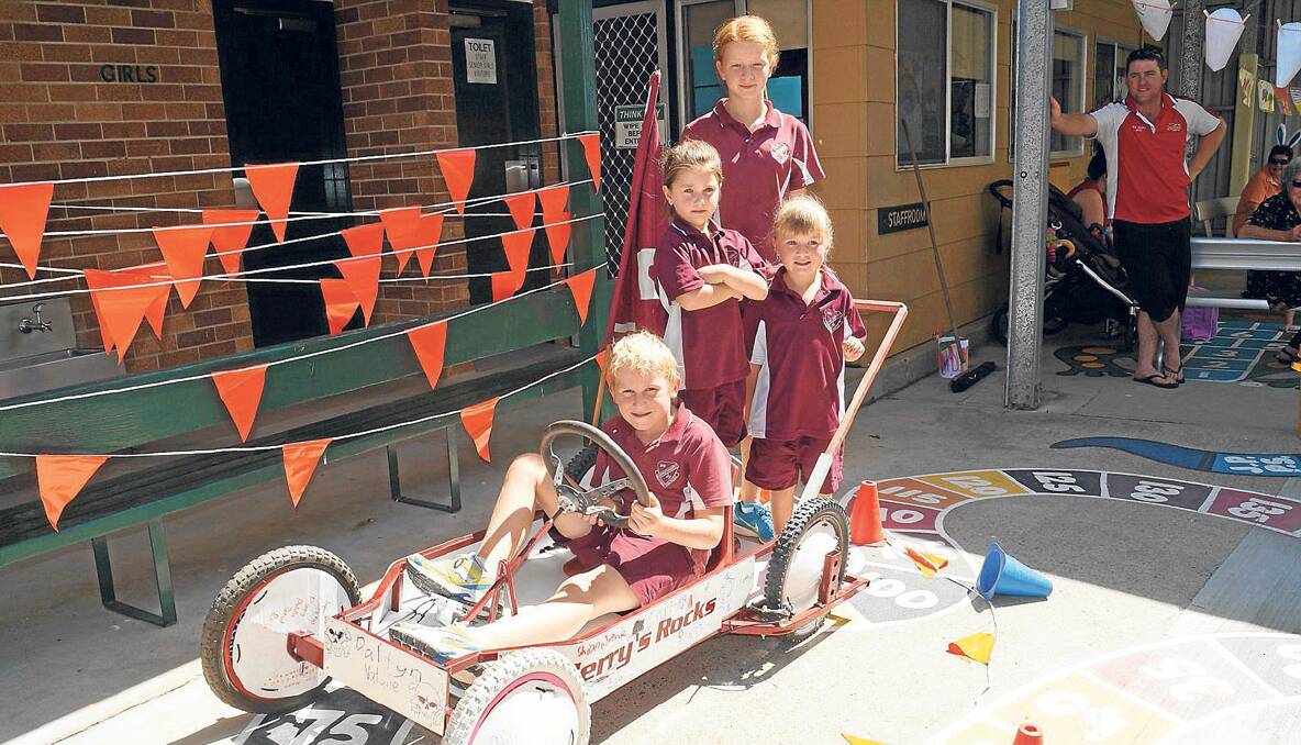READY TO WIN: Jerrys Plains Public School students Daltyn McCartney, Lilly-Jane Williams, Jayda Lambkin and Natalie Lear (back) with the school’s billy cart they created to enter the Gresford Billy Cart Derby on the weekend. 