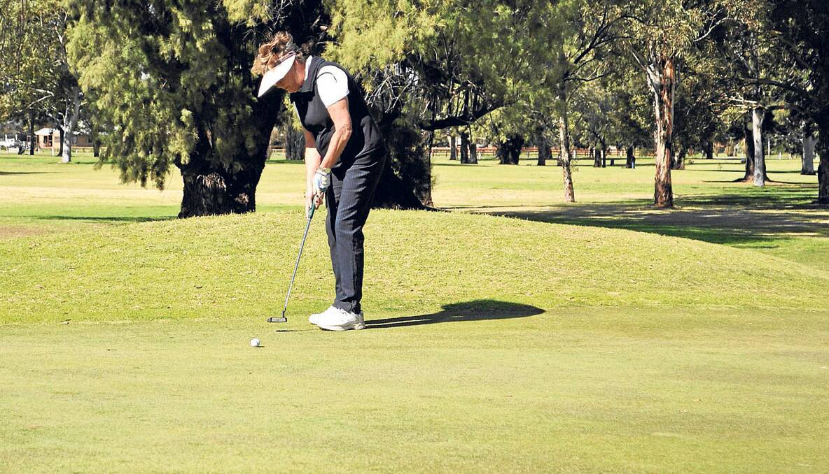 LONG PUTT: Caren Caldwell attempts a big putt during Tuesday’s golf at the Singleton Golf Club. 
