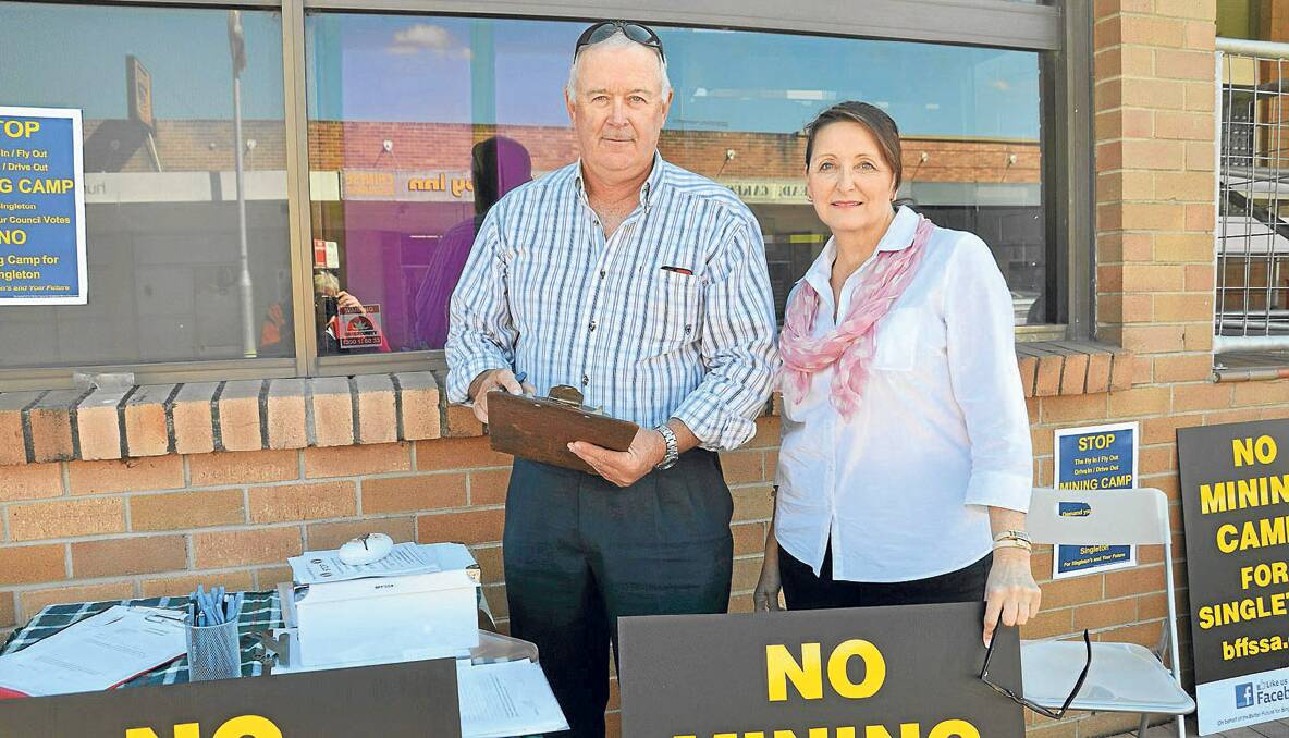 CAMPAIGNING:Better Future For Singleton Shire Association members Robert Ball and Tracey Reid gather submissions against the mine camp outside the Singleton Post Office. 