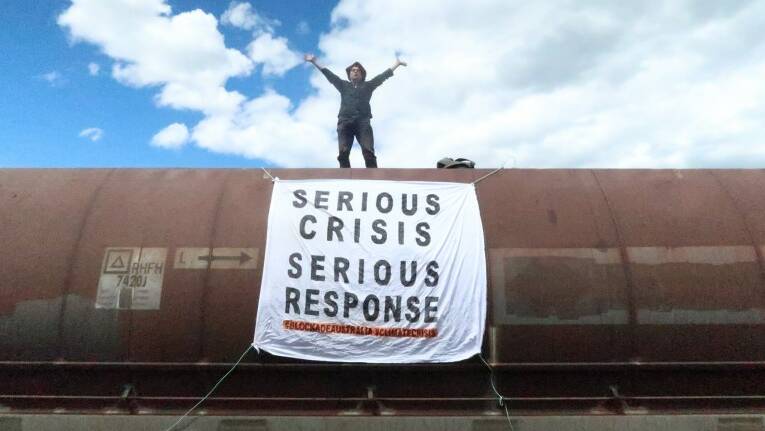 CAMPAIGN: A protester affiliated with the Blockade Australia group standing on a coal train on Sunday, November 14. Picture: Blockade Australia