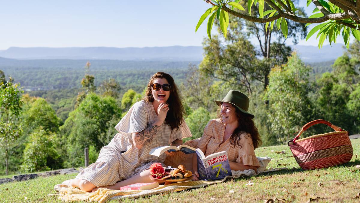 Reading Retreats Australia founders Katie Bleus and Emily Devine on a picnic at the retreat. Picture supplied
