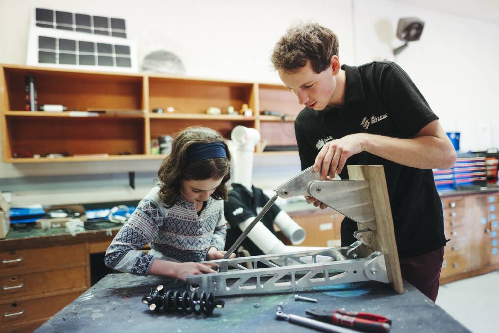 Evelyn on the tools at the ANU solar racing workshop with team member Robin Hodda. Picture: Dion Georgopoulos
