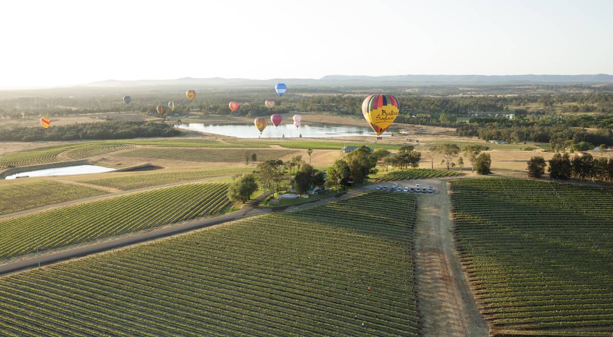 DESTINATION: Hot air balloons fly over the Hunter Valley. Picture: Max Mason-Hubers