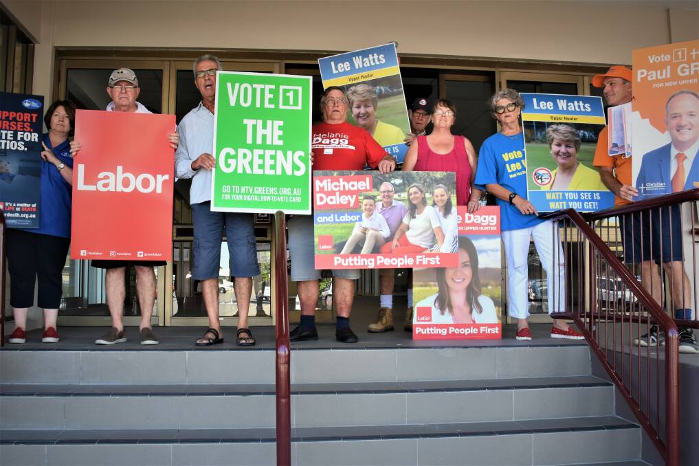 DIFFERENCE: Political party volunteers gathered to protest against the The Nationals Michael Johnsen and Barnaby Joyce during the pair's visit to Singleton.