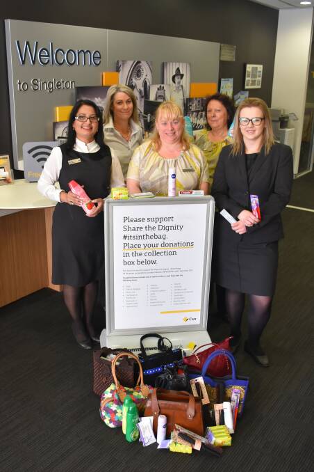 CARE: Kanchan Ranadive, branch manager, Lesa McNaught, Petina Johnson, Bev Clysdale and Monique Brown with some handbags and personal care products collected in the #inthebag campaign.