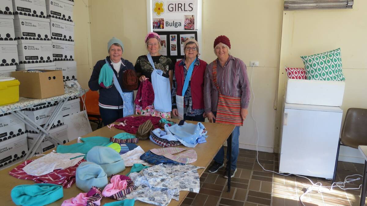 Members of the Bulga Craft Group with some of the beanies they have made for cancer patients