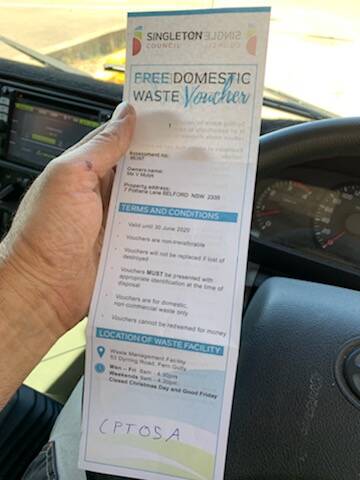 SHOCKED: The free domestic waste voucher held by Vicki Mulyk as she left the Singleton Council Waste Depot. 