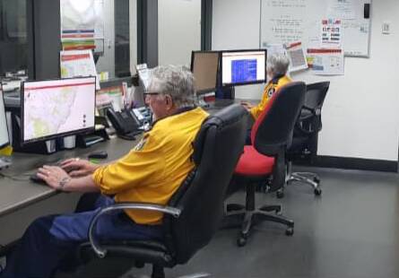 Rural Fire Service Hunter Valley communications brigade volunteers at working at the control centre at Bulga.