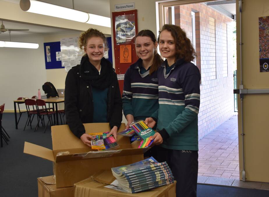 GENEROUS DONATION: Olivia Anderson, Ricki Gibson-Todd and Phoebe Quayle collecting school supplies for Tonga.