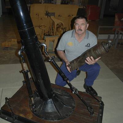  ALMOST READY: Australian Army Museum curator John Land is pictured with a first World War 21 kilogram bomb and its mortar as he helps set up for the museum which was opened in 2011.
