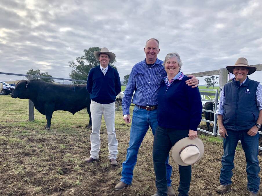 Auctioneer Paul Dooley, Don and Alison Cameron with Ted Laurie and the top priced bull Knowla Packer P130 that sold for $30,000. Photo: Samantha Townsend.