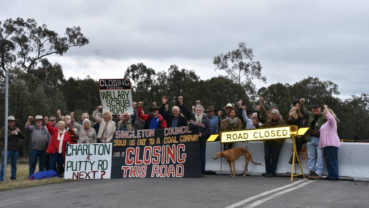 UNHAPPY: Attendees at a rally on Saturday voicing their opposition to the closure of Wallaby Scrub Road.