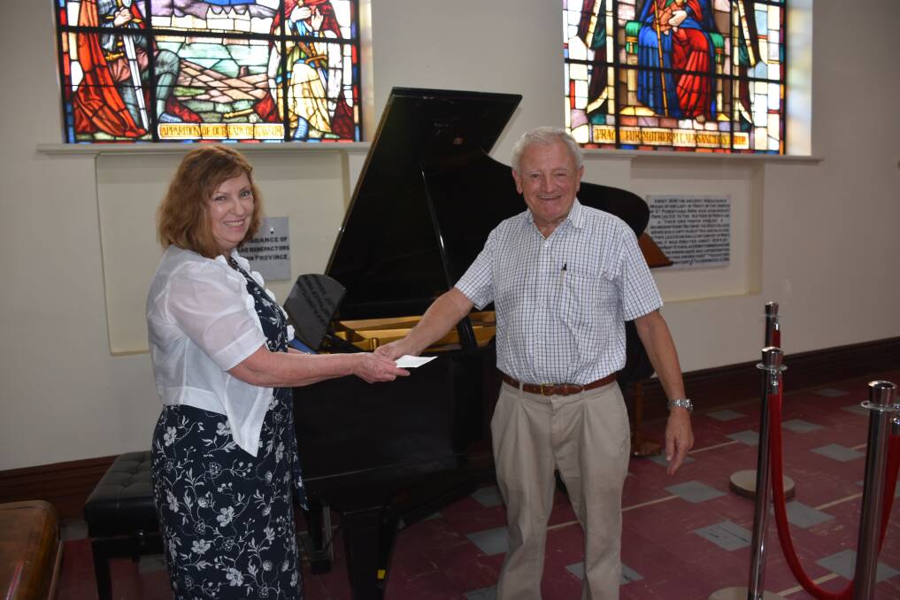 PLEASED: Singleton High School principal Jo Scott and former president of Singleton Arts and Music Society Geoff Dunlop with the baby grand piano which will soon be housed at the school.