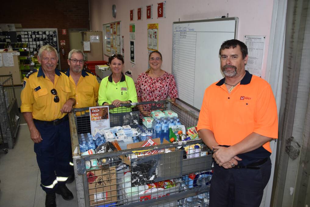 Fred Turner group officer Hunter Valley RFS, Trevor Bendeich, Hunter Valley RFS, Kristy Abernathy, Elisha Munce and Sean Winslade with the donations received from the drive organised by Australia Post's local staff.