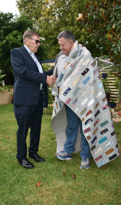 WRAPPED IN WARMTH: Quilts of Valour, NSW Co-ordinator Stan Allen presents fellow Vietnam veteran Ray Paix with his quilt made by family friend Mary Irvine.