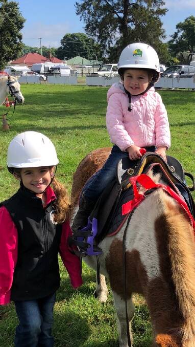 Khloe FitzGerald and her little sister Maddi FitzGerald getting ready for their riding classes. Photo supplied.