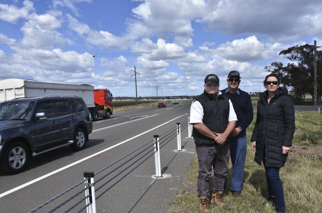 DANGEROUS: Residents Chris Bennett, Robert Ball and Pip Byrnes at the intersection of Racecourse Lane and the New England Highway which was upgraded last year.
