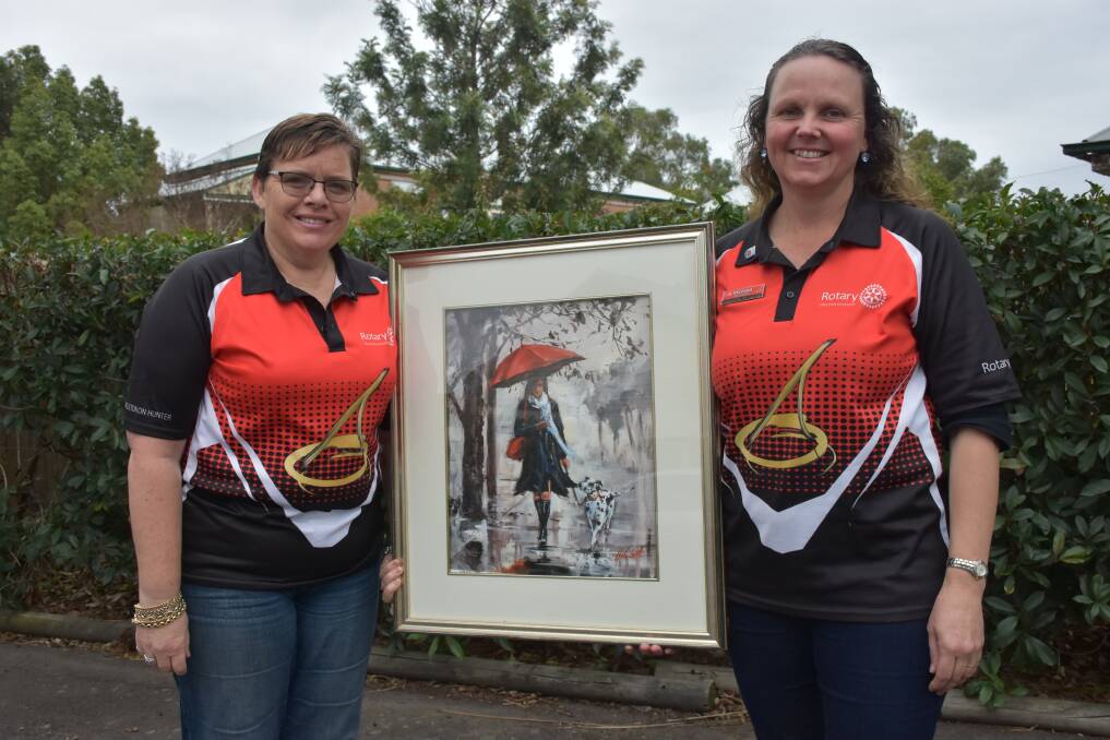 COMMUNITY: Sue Ferguson and Belinda Richards, Rotary Club of Singleton on Hunter with Helen Cottle's 'Winter Walk'. Ms Cottle was a previous judge of the Yancoal Singleton Art Prize.
