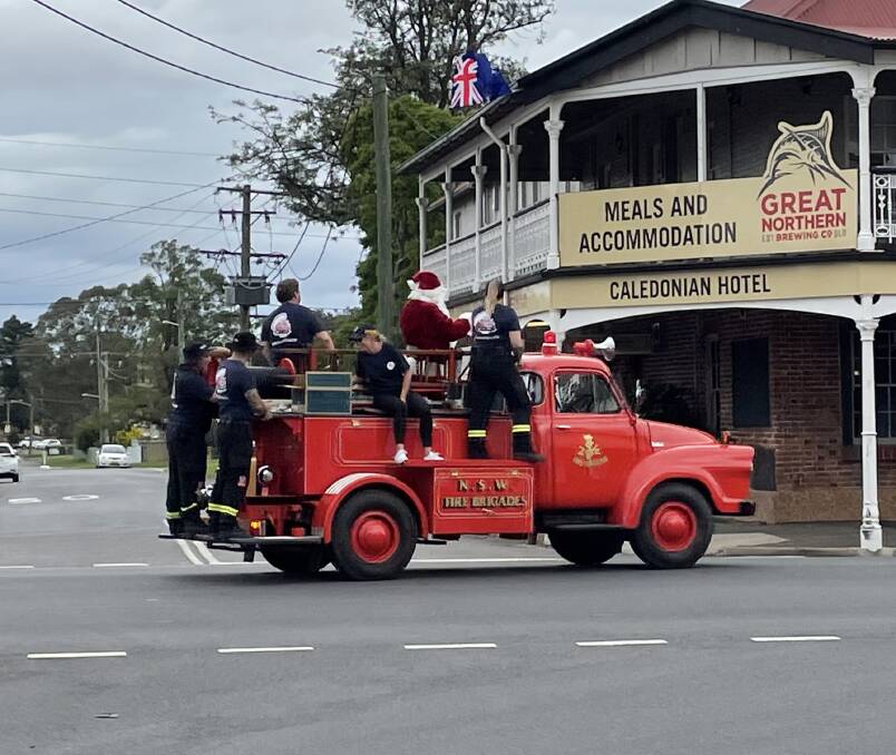 HIT THE HIGHWAY: Santa on board heads down George Street on Monday afternoon for the first day of the annual Lolly Run.