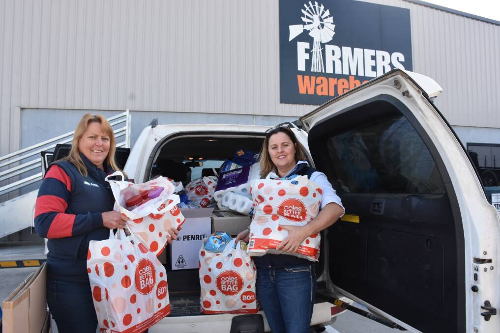 Farmers Warehouse's Jude Metherell with organiser Hollie Doyle loading donated groceries ready for the trip west. 