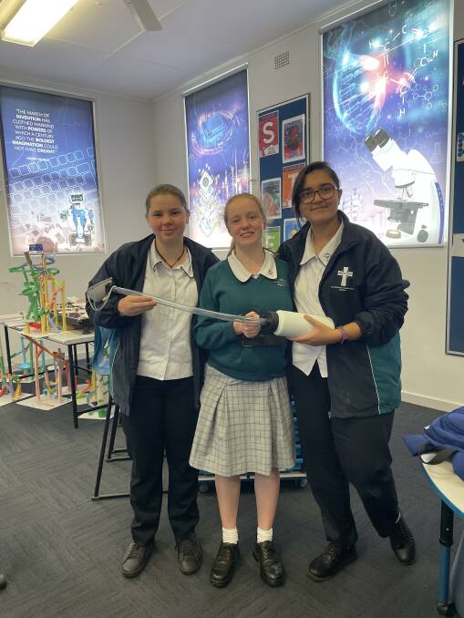 Kaitlyn Dunn, Chloe Brackenrig and Marwa Arain with their space sickness bag which they will showcase at the STEM MAD in Melbourne this week.