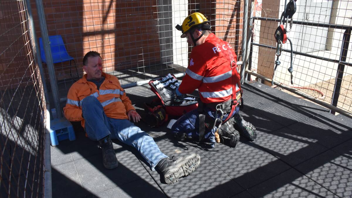 SAFETY FIRST: A member of the Mt Arthur team assists an injured worker during a simulated exercise at the Mines Rescue Competition.