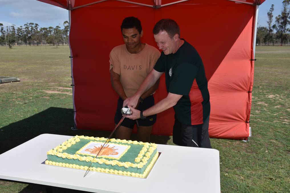 Singleton School of Infantry’s commandant Lieutenant Colonel Matthew Flanagan and the youngest soldier on the base Private Cody Davis cut the birthday cake.