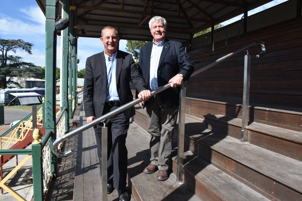Member for Upper Hunter Michael Johnsen and NAA president David Williams check out the new handrails in the showground's grandstand funded by a grand from the  Stronger Country Communities fund.
