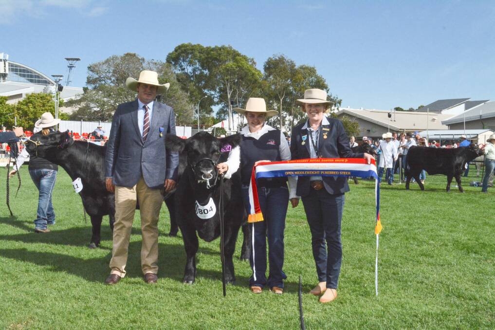 Judge Kieran Te Velde, Bob, Blue Gene Cattle Company's middleweight champion led by Tayla Miller, Parkville, and RAS cattle councillor Alison Hamilton. Photo: Hannah Powe