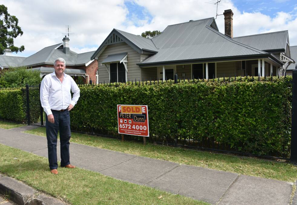 Singleton real estate agent, Peter Dunn, with the latest million dollar sale his business has achieved this month. This property is located in Hunter Street and is the first home sold for a million dollars in central downtown district of Singleton.