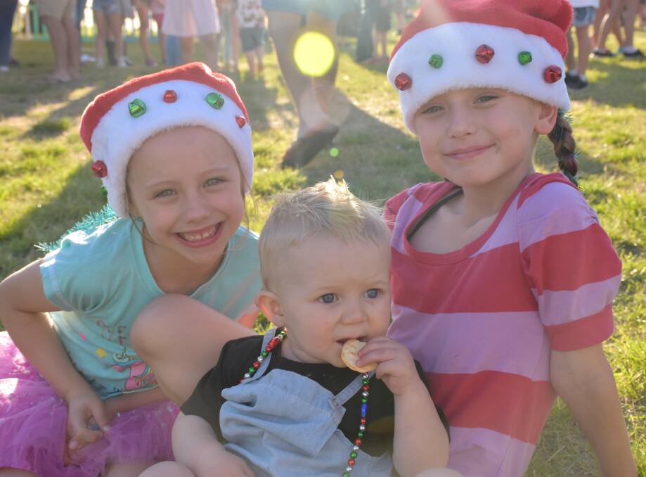 FUN TIMES: Laila and Silvani Bartley with Archer Ward attended the 2017 Community Carols at Allan Bull Reserve.