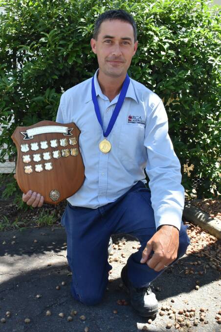 Nic McLaughlin with the trophy and gold medal he won at the National penny farthing championships. 