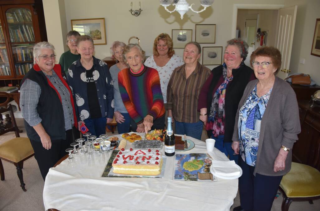 UNITED: Wendy Bowman cuts the cake surrounded by the women who supported her in the campaign to stop a mine being developed on her farm.