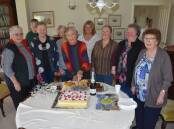 UNITED: Wendy Bowman cuts the cake surrounded by the women who supported her in the campaign to stop a mine being developed on her farm.