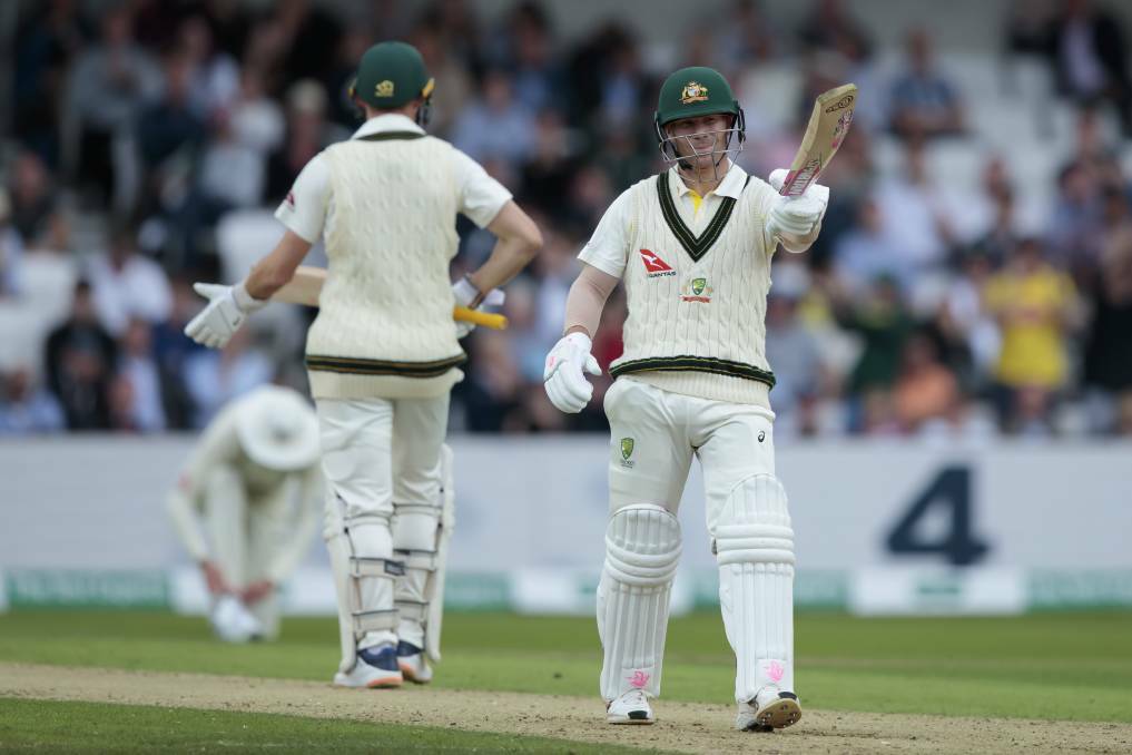 Australia's David Warner raises his bat as he reaches 50 runs on the first day of the third Ashes Test. 