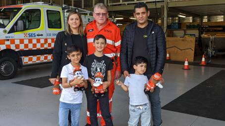 AJ, bottom right, and his family with SES volunteer Bluey.