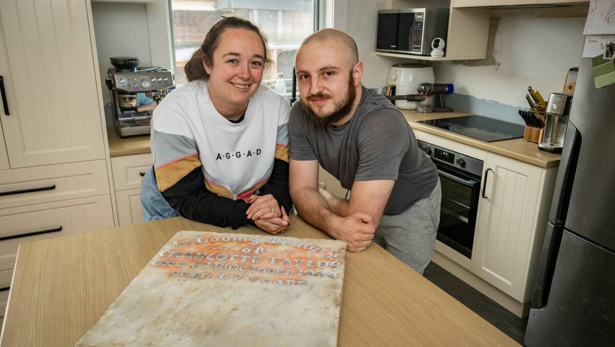 Launceston couple Gemma and Jamie Free found a gravestone in their kitchen bench during a renovation. Picture: Paul Scambler
