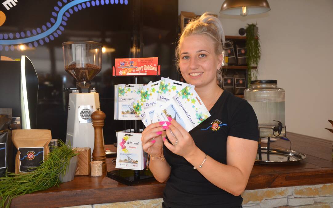 SUPPORTIVE: Wattaka Cafés Helen Sproule showcases the Spend in Singleton gift cards.