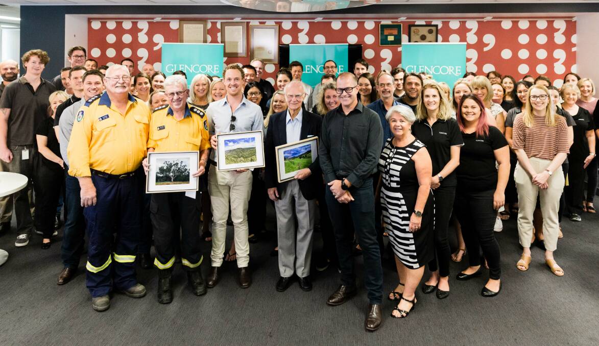 GENEROSITY: Glencore staff with, from left (holding framed photos), Col Scriven, John Hedley (NSW Rural Fire Service), Will Hansen (Aussie Ark) and Dennis Livingston (BlazeAid).