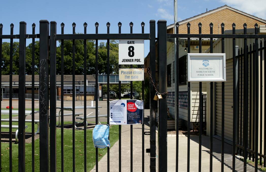The gates of Hamilton South Public School were locked on Tuesday after a positive COVID-19 case. Picture: Jonathan Carroll