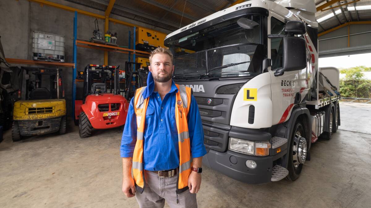 Truck driving trainer Anthony Beck, with the Scania he uses to teach drivers to gain their heavy rigid accreditation. Picture: Sitthixay Ditthavong